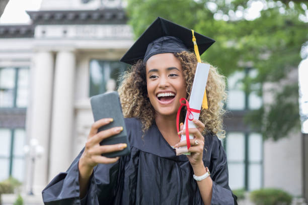 istock College grad takes selfie with diploma 1030376624