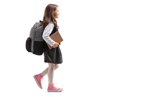 istock Schoolgirl with a backpack walking 1030376834