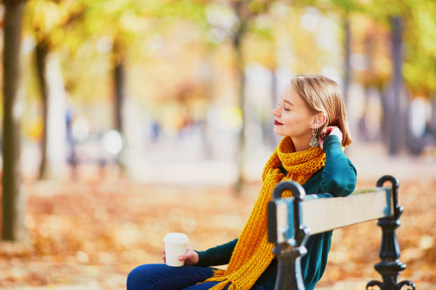 happy young girl in yellow scarf walking in autumn park - autumn women park forest imagens e fotografias de stock