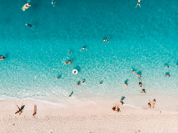 Aerial view of people at the beach,Ionian Islands, Greece Aerial view of people at the beach,Ionian Islands, Greece beach holiday stock pictures, royalty-free photos & images