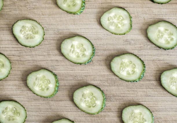 istock Sliced cucumber on a cutting board. Top view. 1030387410