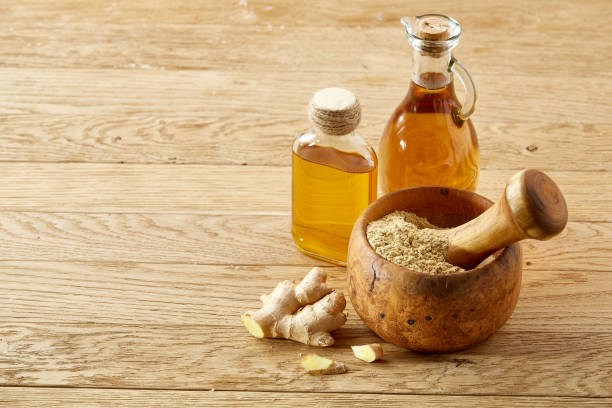 istock Wooden mortar and pestle with ginger and grind spices on rustic table, close-up, selective focus 1030389826