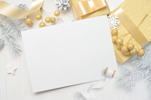 istock abstract christmas background, white sheet of paper lying among small decorations on white wooden desk. Flat lay mockup for your art, picture or hand lettering composition copy space, top view 1030389914