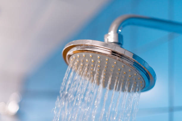 Shower head with refreshing cold water. Water supply is turned on stock photo
