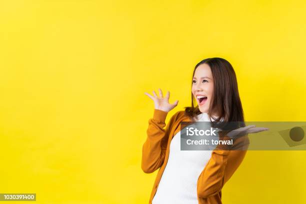 Asian Girl Is Surprised She Is Excitedyellow Background Studio Stock Photo - Download Image Now