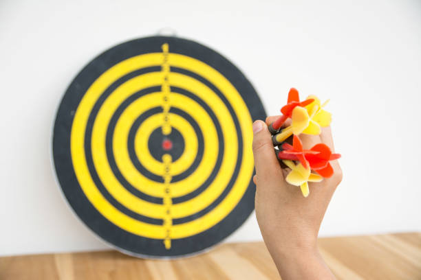 istock Hand holding darts arrow on white background 1030391516