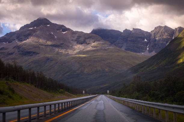 istock Straight road to mountains in Norway 1030394032