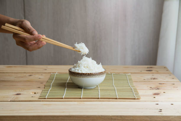 istock Jasmine rice in white cup On a bamboo mat 1030394064