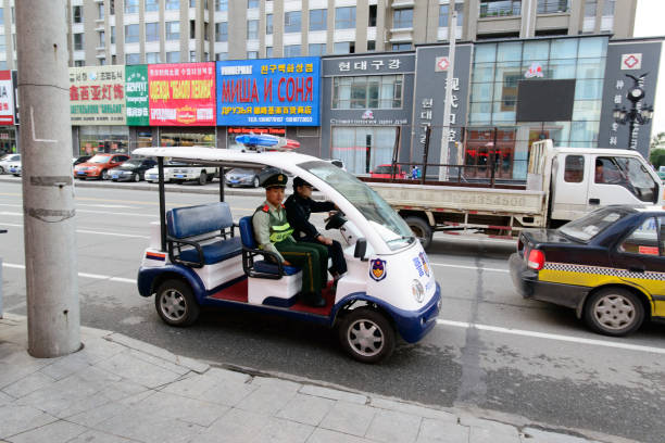 Police patrol on the electric car on the city street. stock photo