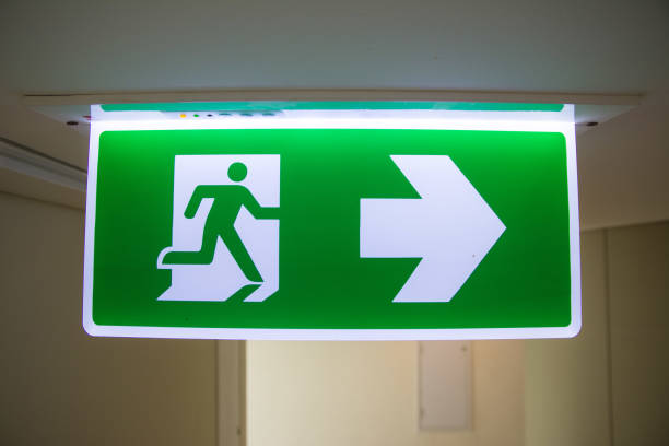 istock Emergency Fire exit sign at  the corridor in building 1030394394