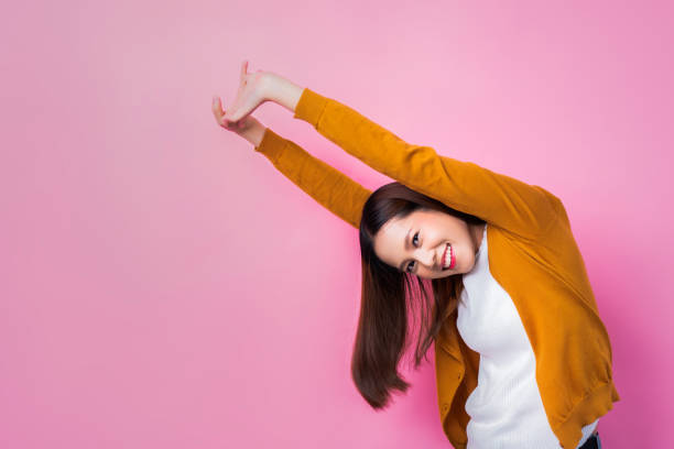 istock Asian women stretching to relax.Pink background 1030395426