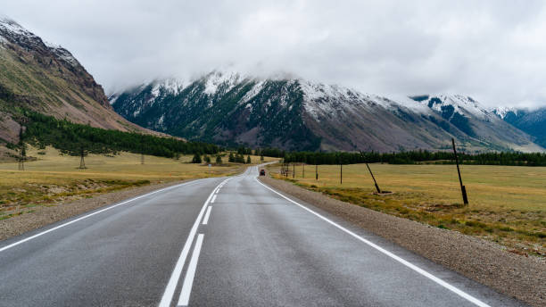 istock Road to the mountains, mountains, clouds and forest on the background 1030395558