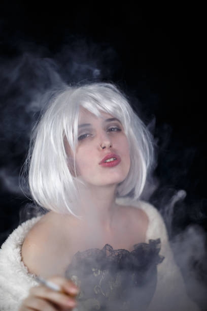 istock Elegant woman smoking cigar 1030398178