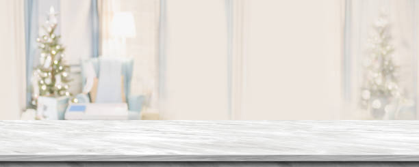 istock Empty grey marble table top with abstract warm living room decor with christmas tree blur background with bokeh light,Holiday backdrop,Mock up banner for display of advertise product ,luxury house. 1030398244