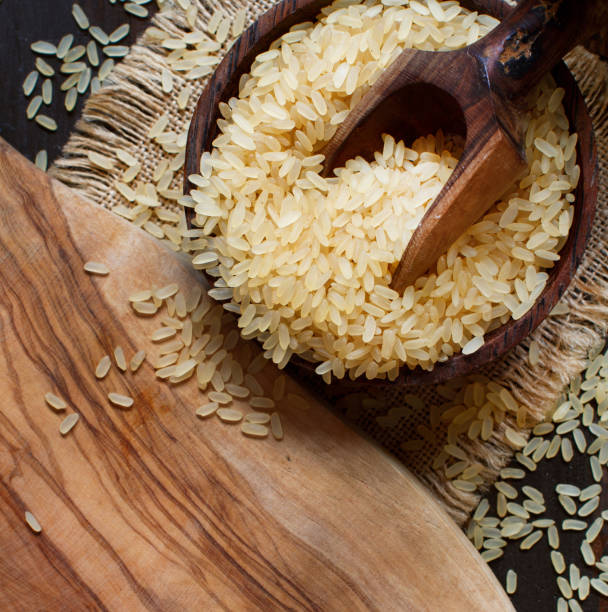 istock Parboiled rice with a wooden spoon 1030398892