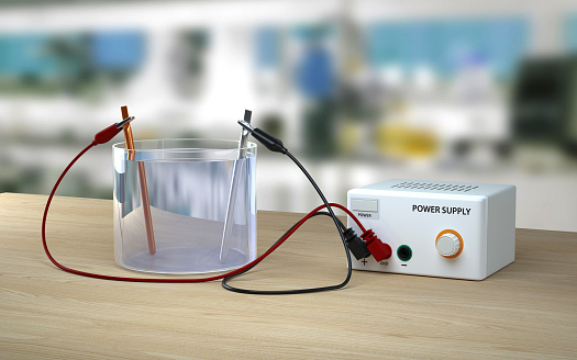 Electrolysis of water on wooden table in lab.