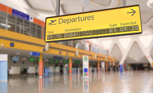 Concept of an airport departures board going to Dubai, including Dubai in native script