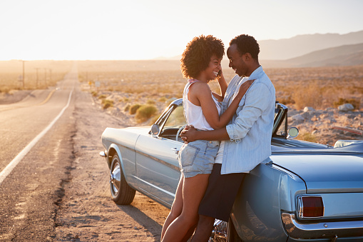 Romantic Couple Enjoying Road Trip In Classic Car