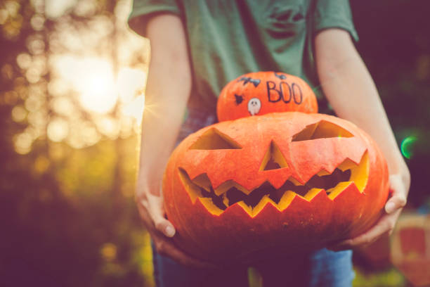 Women's hands holding pumpkins
