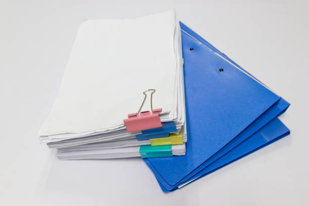istock Blue files folder and paper on white table in office 1030409650