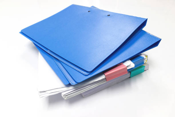 istock Blue files folder and paper on white table in office 1030409788