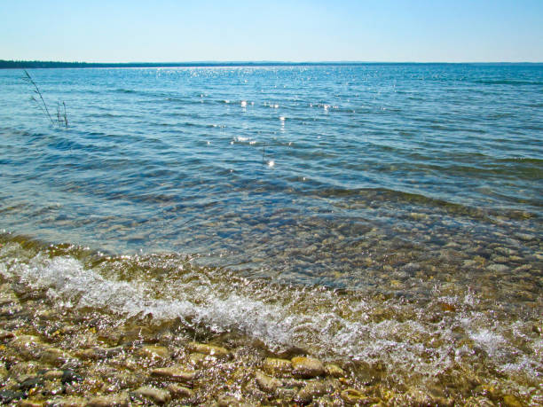 istock Transparent water and pebbles on the beach coast. 1030413788