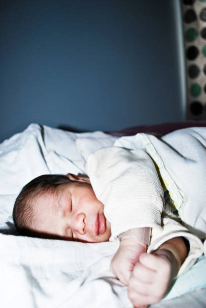 istock Newborn Baby Sleeping In Bed 1030415492