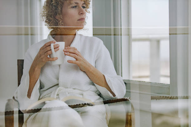 istock Woman reading a book holding a coffee cup 1030428626