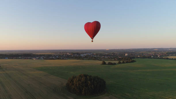 istock Hot air balloon shape heart in sky 1030429036