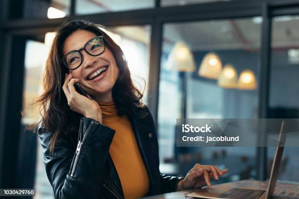 Smiling Business Woman In Casuals Talking On Phone Stock Photo - Download Image Now - Using Phone, Happiness, Women
