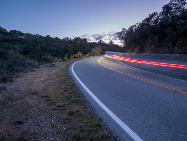 istock Car Speeding On Country Road At Dusk 1030430032