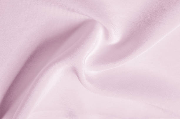 istock Texture background pattern. Pink silk fabric. Closeup of a rippled pink silk fabric. Advertising space. Smooth elegant pink silk can be used as a wedding background. 1030433712