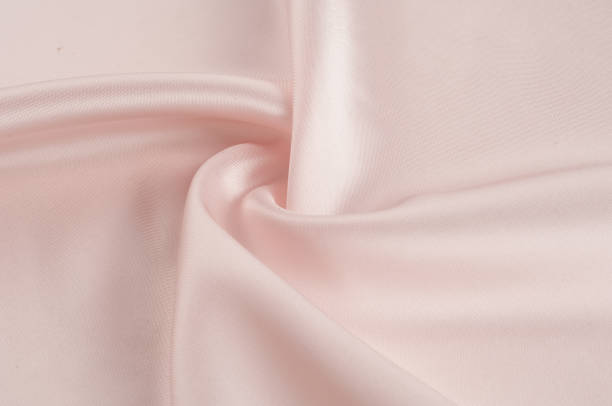 istock Texture, background, pattern. Fabric silk pink background. Beautiful pink satin. Drapery background. winds waves, creating a beautiful background of the folds. 1030433992