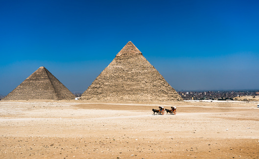 Great pyramids in Giza valley and rider on horse. Egypt