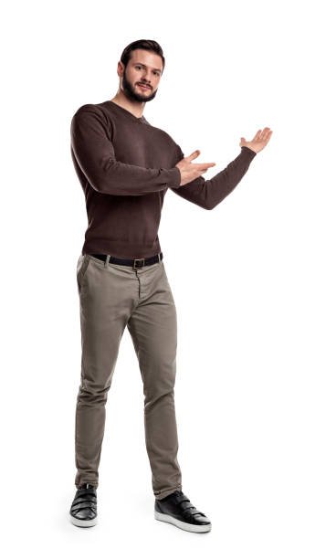 istock A bearded man in casual clothes makes a short step and presents something indicating with his both arms 1030437940