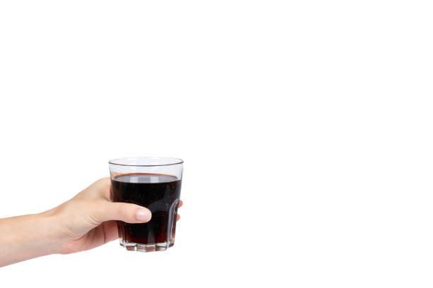 istock Cola drink in glass with hand isolated on white background, copy space template 1030439098