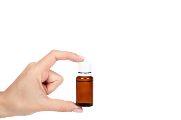 istock Brown glass medicine bottle with hand isolated on white background, copy space template 1030439222