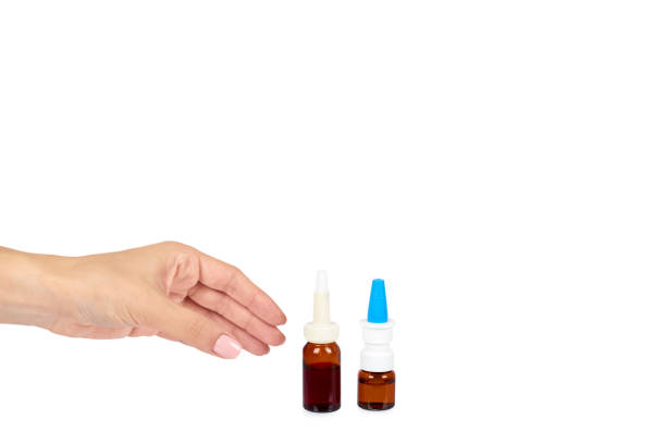 istock eye or ear drops glass bottle with hand isolated on white background, copy space template. 1030441738