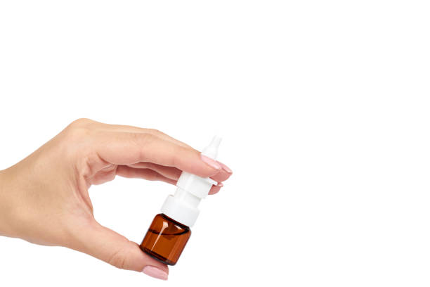 istock eye or ear drops glass bottle with hand isolated on white background, copy space template. 1030441746