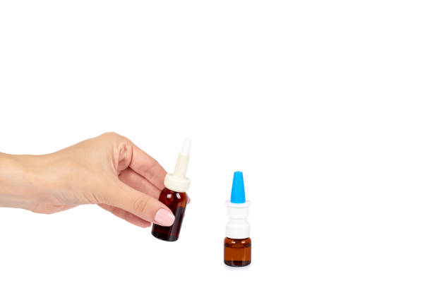istock eye or ear drops glass bottle with hand isolated on white background, copy space template. 1030441770