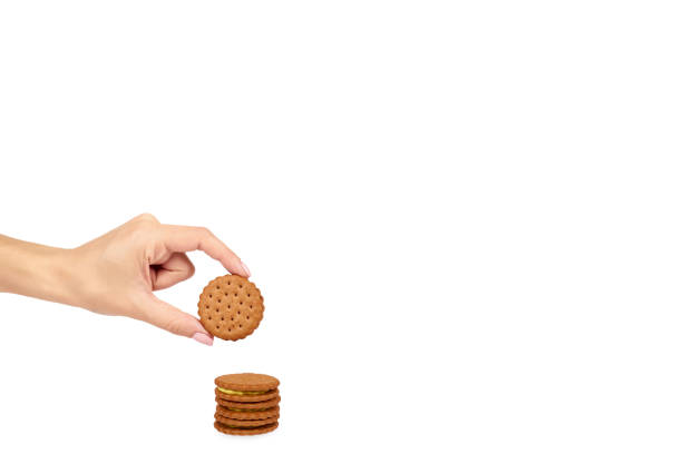 Cookies with cream filling with hand isolated on white background, copy space template