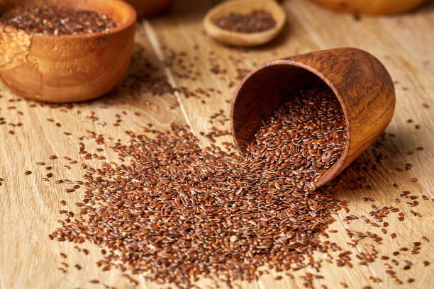 istock An overturned wooden bowl with linseeds on a rustic background, close-up, shallow depth of field, selective focus 1030441908