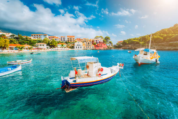 Assos village on Kefalonia island, Greece. White boats in the emerald rippled sea water bay Assos village on Kefalonia island, Greece. White boats in the emerald rippled sea water bay. corfu stock pictures, royalty-free photos & images