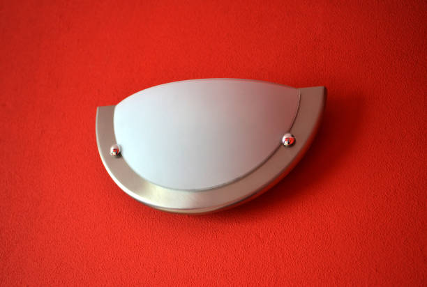 Wall lamp sconce in a modern red room.