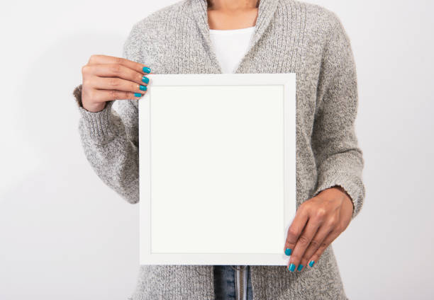 istock Hand Holding Blank white Photo Frame for Design Mockup Template. 1030452110