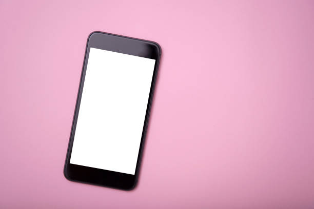 istock Mobile phone and blank screen for mockup template advertising and branding technology on pink background. 1030452196