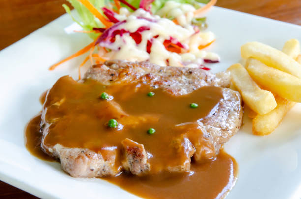 Pork chop steak with brown gravy sauce