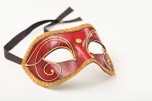 Traditional luxurious Italian red female mask on a pink background. A Venetian elegance masquerade mask for a festival. Mardi Gras.