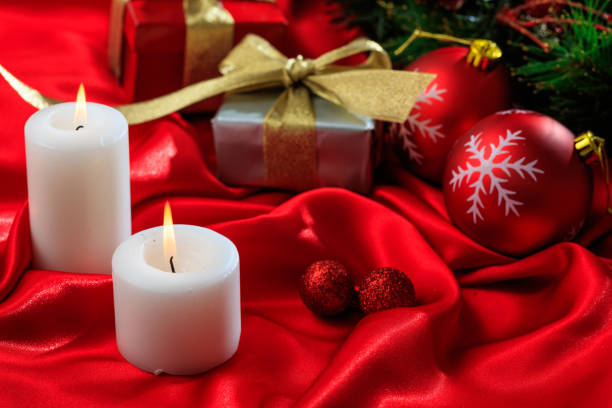 istock Gift boxes and candles on red satin 1030458428