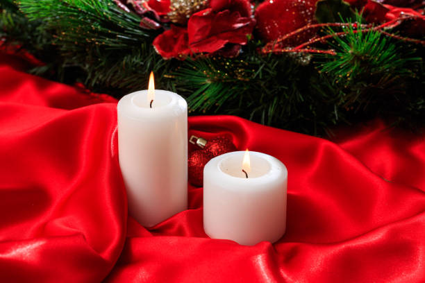 Candles on red satin background